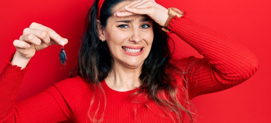 A picture of a woman holding a cockroach and disgusted by it
